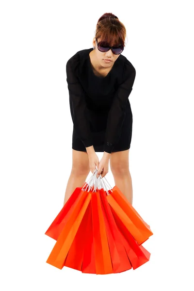 Young asian woman carries shopping bags Stock Picture