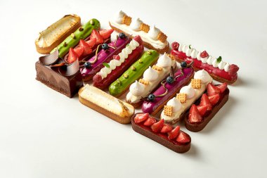 A set of different eclairs with filling. Selective focus, close-up