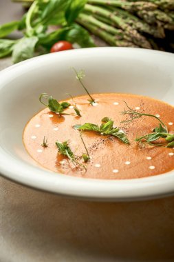 Pumpkin cream soup with jamon and sausages. Noise added in post-production. Selective Focus.