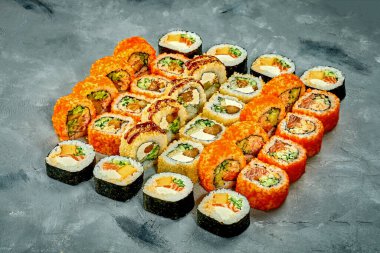 Set of sushi rolls with different fillings on a gray background. Selective Focus. Noise graine add on post