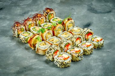 Set of sushi rolls with different fillings on a gray background. Selective Focus. Noise graine add on post