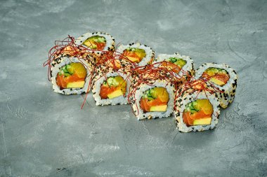 Somonlu sushi dürümü, avokado, gri arka planda salatalık. Yapım sonrası ses eklendi