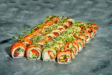 Set of sushi rolls with different fillings on a gray background. Selective Focus. Noise graine add on post