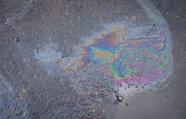 Asfaltta doku ya da arka plan olarak renkli yağ ya da benzin lekeleri var. Çevre kirliliği kavramı