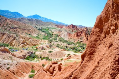 Scenic red rocks in the mountains of Kyrgyzstan clipart