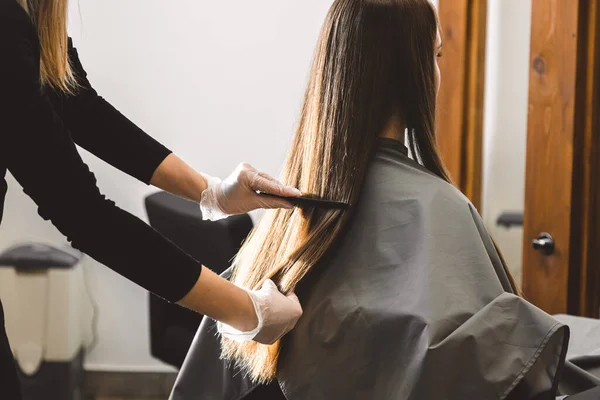 Maestro peluquero peina el cabello de las niñas después de lavar y antes de peinar en un salón de belleza. — Foto de Stock