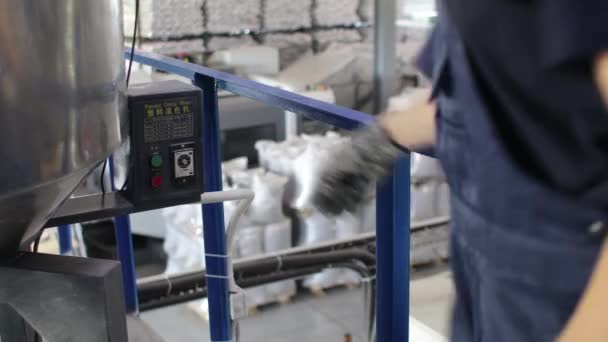 El trabajador presiona un botón y enciende el mezclador automático. Fabricación de productos de polipropileno — Vídeo de stock