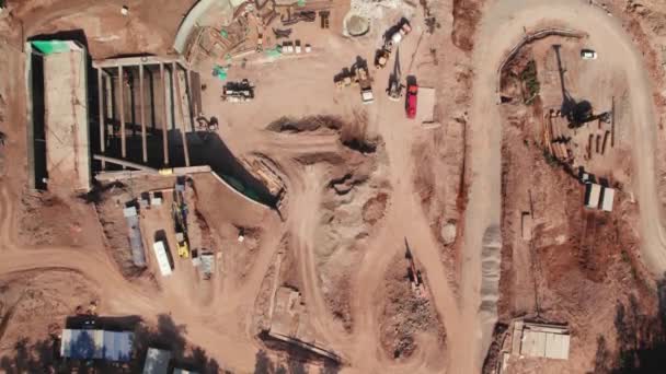 View from a height to the construction site. Aerial drone footage of construction site, special equipment and workers — Stock Video