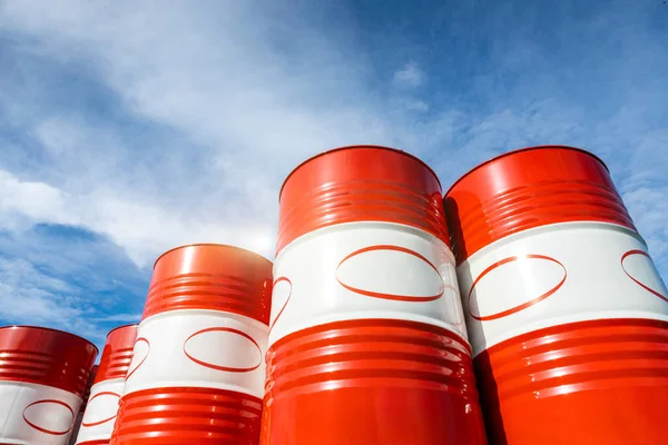 Red-white barrels with oil. Warehousing containers ready for shipment. Refining and selling oil derivatives