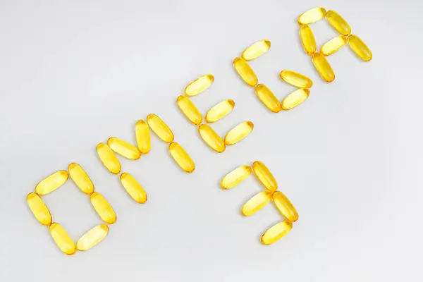 Translucent Fish Oil Capsules Arranged Lettering Omega Isolated White Power — 图库照片