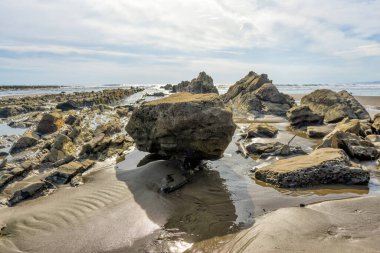 Group of eroded rocks on a sandy beach of Puntarenas Province of Costa Rica.