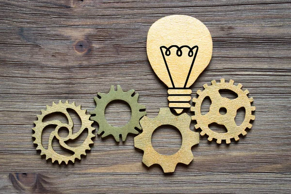 Cogs Wooden Lightbulb Symbol Connected Wooden Background Creative Idea Development — Stockfoto