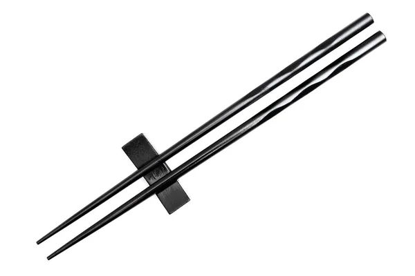 Κοντινό Πλάνο Μαύρων Chopsticks Τοποθετημένων Βάση Ανάπαυσης Απομονωμένη Λευκό Φόντο — Φωτογραφία Αρχείου