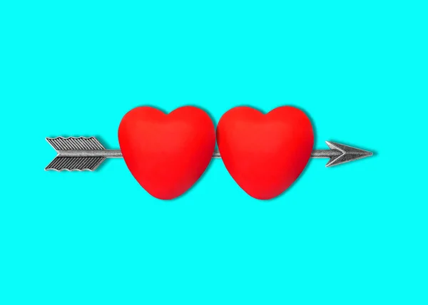 Two Heart Shapes Pierced Steel Bow Arrow Isolated Blue Background — Φωτογραφία Αρχείου