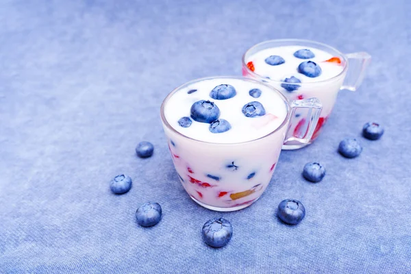 Two Glass Cups Refreshing Summer Berries Mix Yogurts Matching Blue — Stockfoto