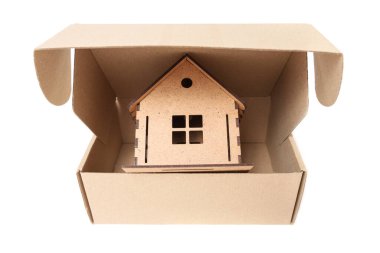 Assembled toy house in a cardboard box isolated on white. Relocation service concept.