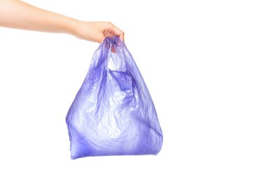 Used purple disposable bag in hand isolated on white background