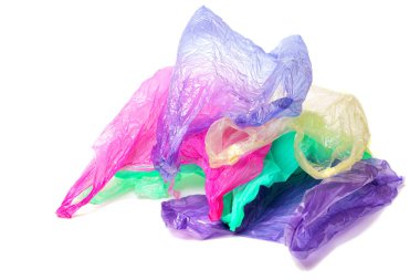 Pile of used multicolored disposable bags with handles isolated on white background