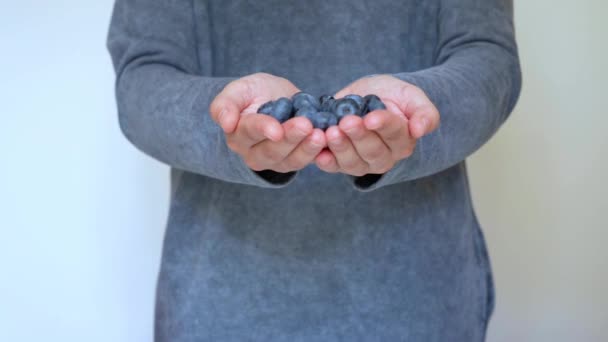 Woman Extends Both Hands Full Fresh Blueberries Closer Camera — Stok video