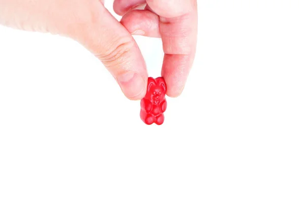 Hand Pinch Holding Squeezing Red Gummy Bear Candy Isolated White — Stockfoto