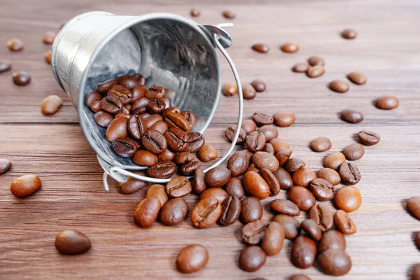 Dark Roasted Coffee Beans Spilled Miniature Steel Bucket Wooden Table — Stok fotoğraf