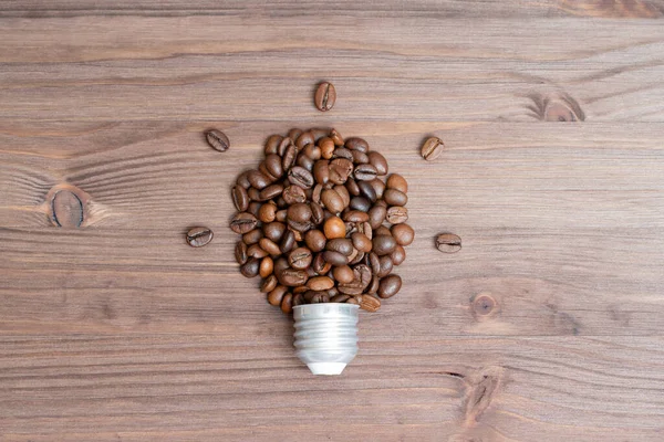 Glowing Light Bulb Shape Made Coffee Beans Cap Wooden Table — Fotografia de Stock