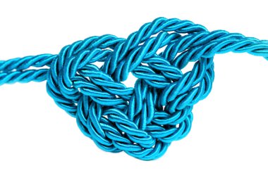 Blue heart shape made from braided cords isolated on white background. Creative mood related concept.