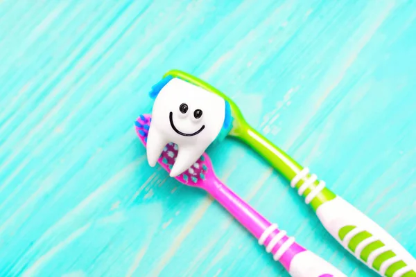 Cute Smiling Tooth Character Two Vivid Toothbrushes Isolated Blue Wooden — Stock Photo, Image