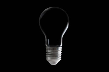 Incandescent light bulb with no filament inside isolated on black. Alternative power source concept.