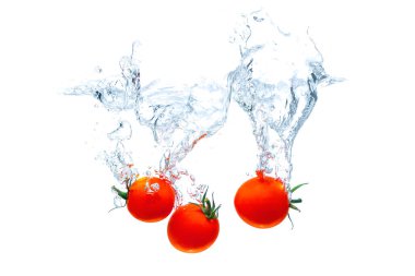 Cherry tomatoes dropped in water with big splashes isolated on white background.