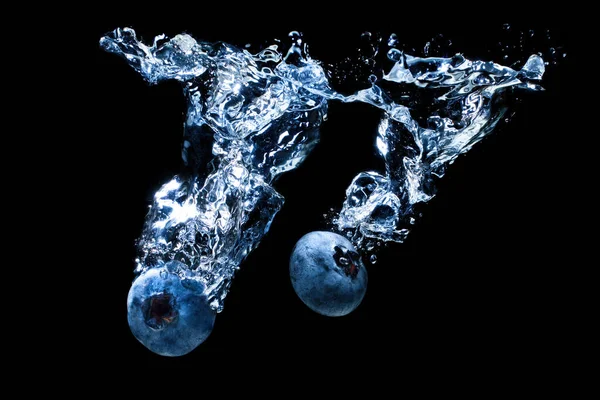 Two Fresh Ripe Blueberries Rushing Underwater Splashes Whirlpools Isolated Black — Stock fotografie