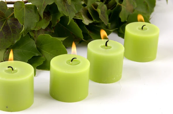 Burning candle and ivy leaves — Stock Photo, Image