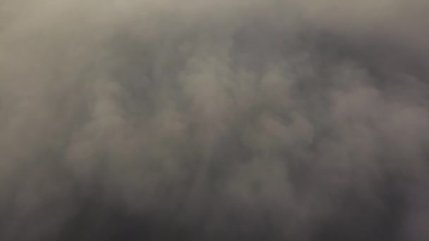 Silhouetten van hoge huizen door de binnenkomende dikke mist. Megalopolis in witte wolken in de vroege ochtend op tijd. — Stockvideo