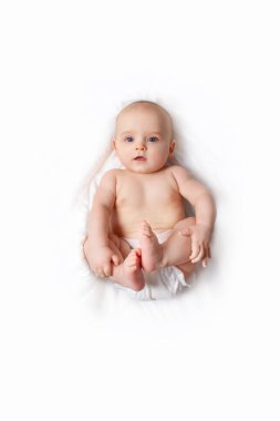 Caucasian baby on white blanket. Top view. clipart