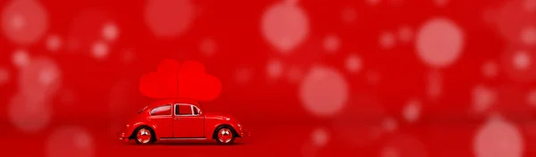 Small red car with two red hearts. — Stock Photo, Image