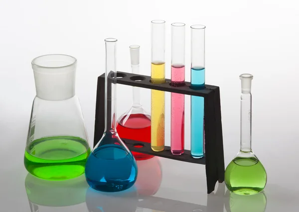 Laboratory glassware filled with various coloured liquids. — Stock Photo, Image