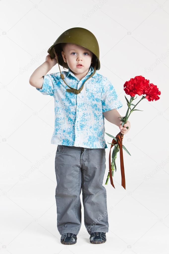 Boy with army helmet and carnations, isolated on white