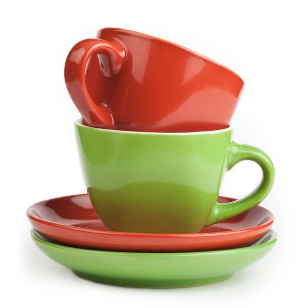 Pila di tazze da tè rosse e verdi e piattini — Foto Stock