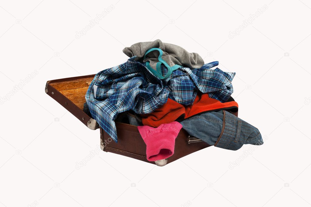 stack of clothes in opened suitcase isolated on white background