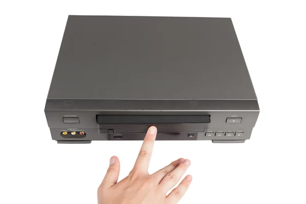 Hand inserts videocassette in videorecorder — Stock Photo, Image