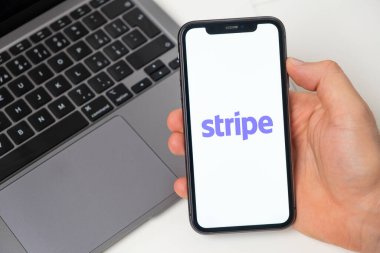 Cep telefonu ekranında şeritli şifreli cüzdan logosu ve arka planda not defteri, Kasım 2021, San Francisco, ABD