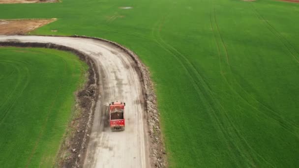 Tatra red truck transports soil from the field along a dirt road, October 2021, Prague, Czech Republic — Wideo stockowe
