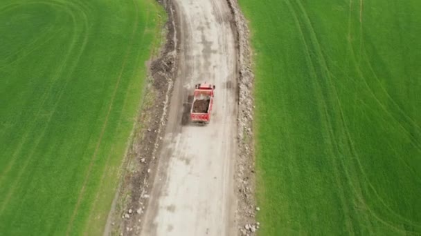 Tatra red truck transports soil from the field along a dirt road, October 2021, Prague, Czech Republic — 비디오