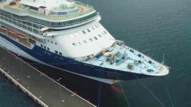 Aerial footage of the stern of the touristic cruise ship moored in marina. Camera turns around the deck, October 2021, Zadar, Croatia