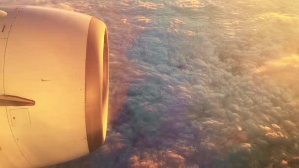 View from the airplane window of the turbine and floating cotton clouds — Video