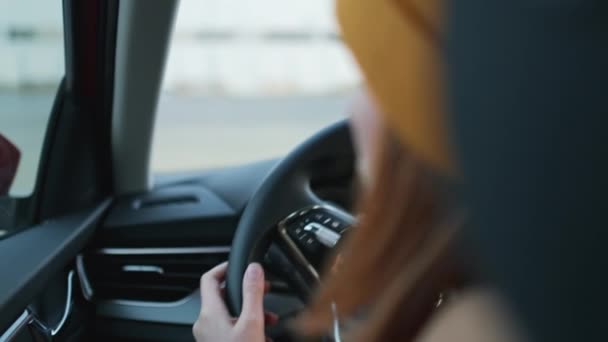 Woman driving Skoda car, hand on steering wheel, turns on the turn signal to the right, shooting from the back seat. Safety driving concept December 2021, Prague, Czech Republic. — Stockvideo