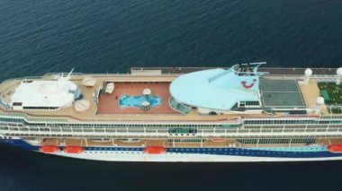 Drone footage along the desk of luxury cruise ship or linear with a swimming pool on the roof moored in marina, October 2021, Zadar, Croatia