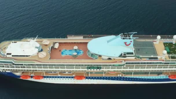 Drone footage along the desk of luxury cruise ship or linear with a swimming pool on the roof moored in marina, October 2021, Zadar, Croatia — Vídeo de stock