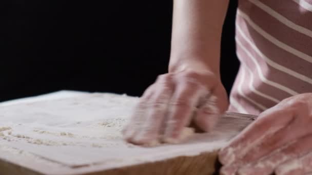 Lady sprinkles white flour on board for making tasty pastry — Stock Video