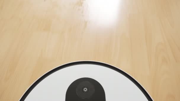 Κάτοψη μιας λευκής ρομποτικής ηλεκτρικής σκούπας που καθαρίζει το ξύλινο πάτωμα. Πυροβολισμός από το πρώτο άτομο. Έξυπνο σπίτι έννοια — Αρχείο Βίντεο